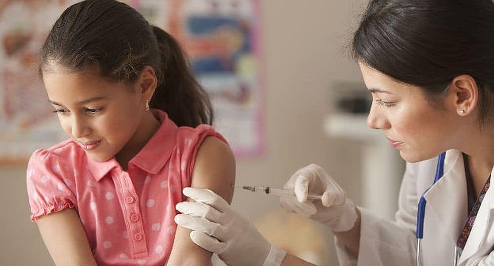 enfermera vacunando adolescente contra hepatitis B